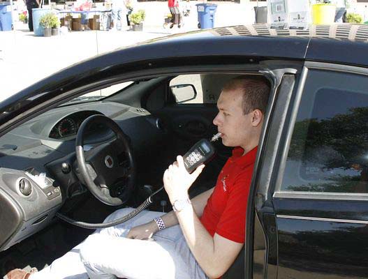 a man blows into an ignition interlock device
