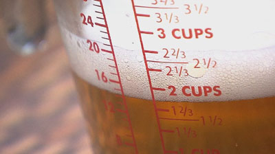 A measuring cup full of beer