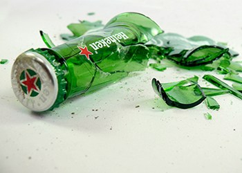 A broken Heineken bottle representing their broken promise to the American consumer